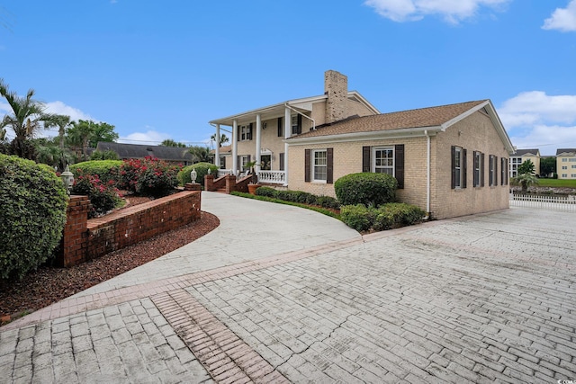 328 Waterside Dr, Myrtle Beach, SC 29577 - view of front of house featuring a chimney, covered porch, and brick siding