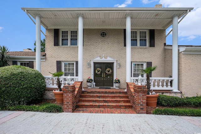 328 Waterside Dr, Myrtle Beach, SC 29577 - greek revival house with covered porch, brick siding, and french doors