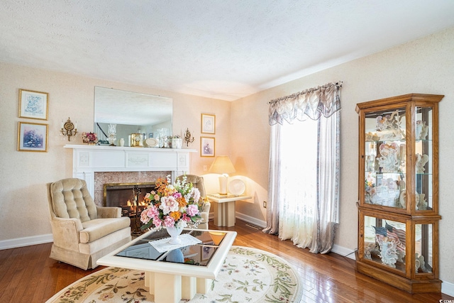 328 Waterside Dr, Myrtle Beach, SC 29577 - living room featuring hardwood / wood-style flooring, a fireplace, baseboards, and a textured ceiling