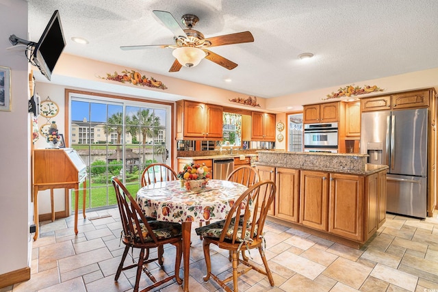 328 Waterside Dr, Myrtle Beach, SC 29577 - dining room with a textured ceiling, ceiling fan, and light stone finish flooring