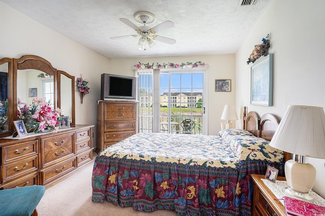 328 Waterside Dr, Myrtle Beach, SC 29577 - carpeted bedroom featuring access to exterior, a textured ceiling, and ceiling fan