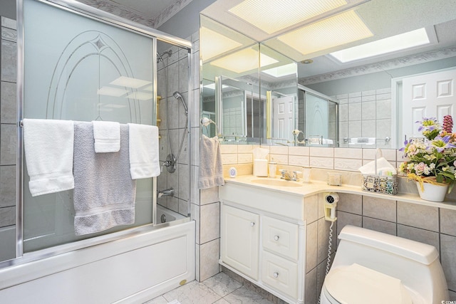 328 Waterside Dr, Myrtle Beach, SC 29577 - bathroom with marble finish floors, combined bath / shower with glass door, vanity, toilet, and tile walls