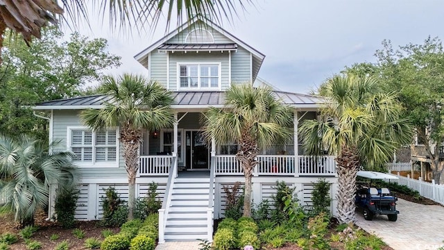 70 Beachwalker Ct, Georgetown, SC 29440 - coastal home with covered porch, stairs, a standing seam roof, and metal roof