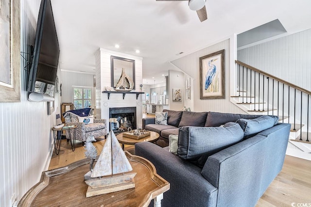 70 Beachwalker Ct, Georgetown, SC 29440 - living room featuring wood finished floors, a fireplace, stairs, ceiling fan, and crown molding