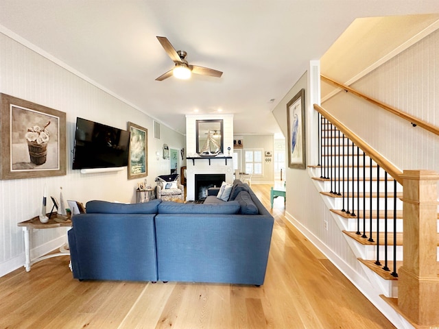70 Beachwalker Ct, Georgetown, SC 29440 - living room with light wood-style flooring, a fireplace, stairway, ceiling fan, and baseboards