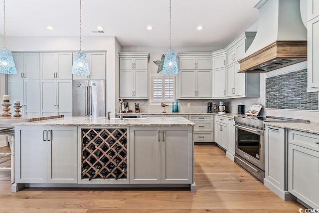 70 Beachwalker Ct, Georgetown, SC 29440 - kitchen with custom range hood, stainless steel appliances, an island with sink, backsplash, and recessed lighting