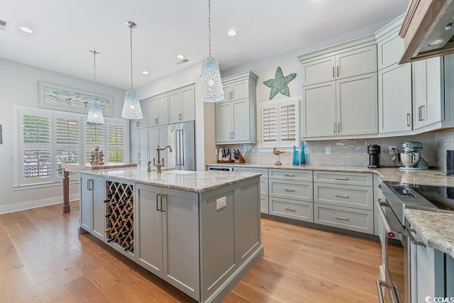 70 Beachwalker Ct, Georgetown, SC 29440 - kitchen with gray cabinetry, custom exhaust hood, tasteful backsplash, stainless steel stove, and recessed lighting