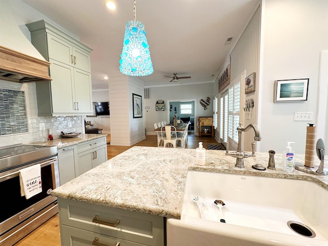 70 Beachwalker Ct, Georgetown, SC 29440 - kitchen featuring a sink, custom exhaust hood, ceiling fan, light wood-type flooring, and stainless steel range with electric stovetop
