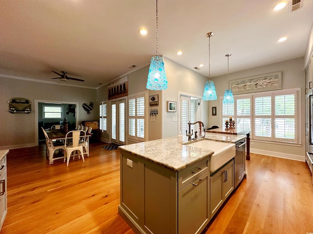 70 Beachwalker Ct, Georgetown, SC 29440 - kitchen featuring a sink, dishwasher, light wood-style floors, a kitchen island with sink, and decorative light fixtures