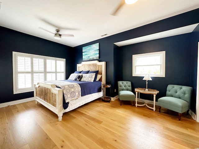 70 Beachwalker Ct, Georgetown, SC 29440 - bedroom featuring light wood-type flooring, a ceiling fan, baseboards, and an accent wall