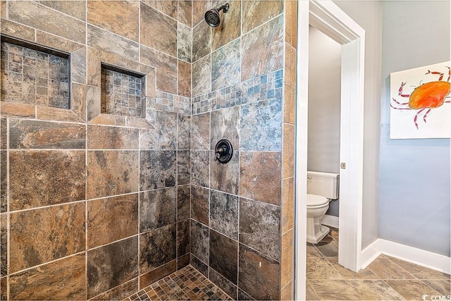 70 Beachwalker Ct, Georgetown, SC 29440 - bathroom with a tile shower, toilet, and baseboards