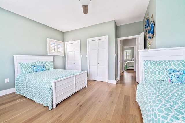 70 Beachwalker Ct, Georgetown, SC 29440 - bedroom with two closets, light wood-type flooring, multiple windows, and baseboards