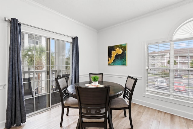 4705 Wild Iris Dr Unit 201, Myrtle Beach, SC 29577 - dining room featuring plenty of natural light, crown molding, light wood-style floors, and baseboards
