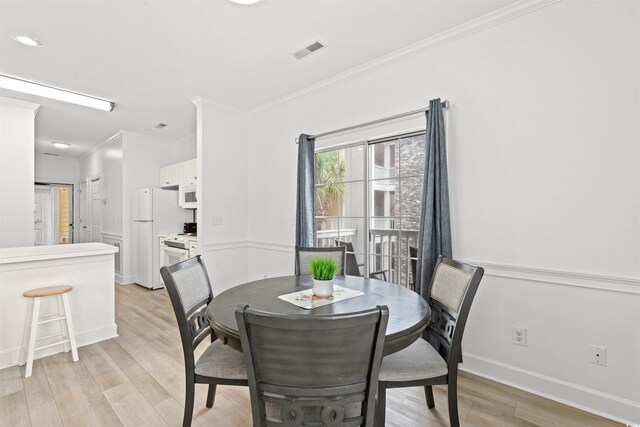 4705 Wild Iris Dr Unit 201, Myrtle Beach, SC 29577 - dining room featuring light wood finished floors, crown molding, and baseboards