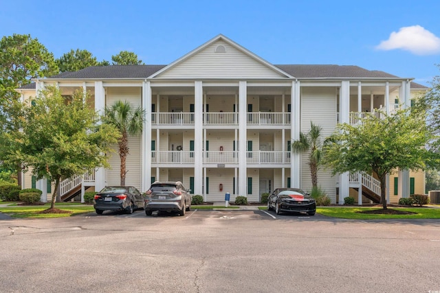 6000 Windsor Green Way Unit 104, Myrtle Beach, SC 29579 - view of building exterior with stairs and uncovered parking