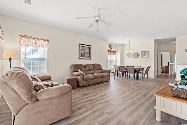 6000 Windsor Green Way Unit 104, Myrtle Beach, SC 29579 - living room featuring light wood finished floors, a ceiling fan, and a chandelier