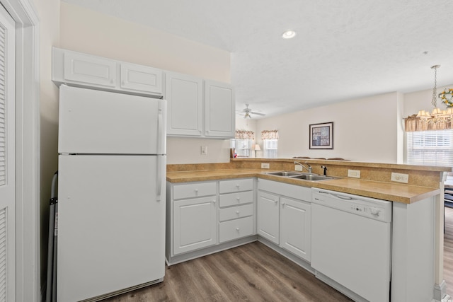 6000 Windsor Green Way Unit 104, Myrtle Beach, SC 29579 - kitchen featuring white appliances, a peninsula, plenty of natural light, wood finished floors, and recessed lighting