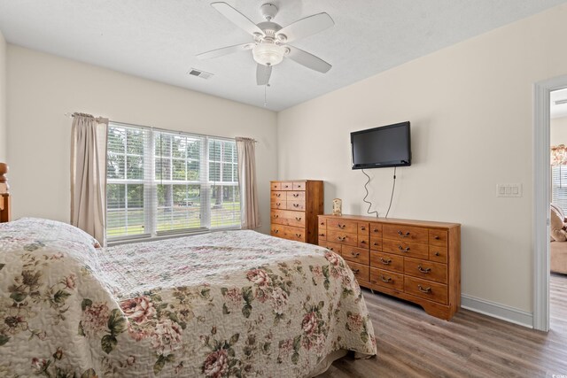 6000 Windsor Green Way Unit 104, Myrtle Beach, SC 29579 - bedroom featuring wood finished floors and ceiling fan