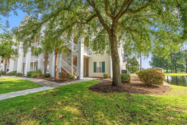 6000 Windsor Green Way Unit 104, Myrtle Beach, SC 29579 - view of property featuring stairs, a front lawn, and a water view