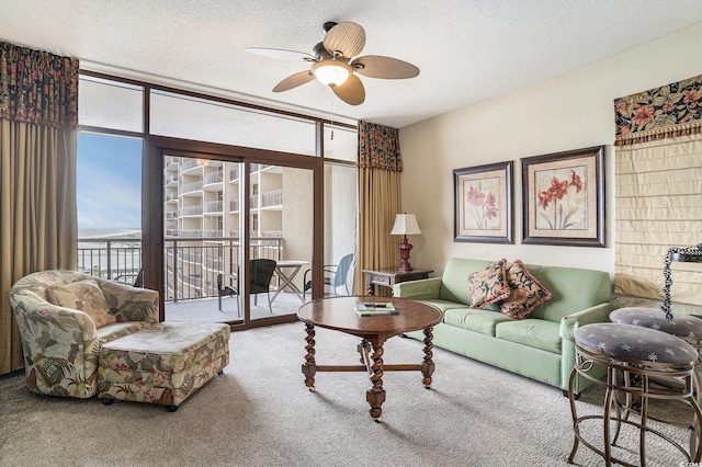 100 N Beach Blvd Unit 710, North Myrtle Beach, SC 29582 - living room with a ceiling fan, expansive windows, carpet flooring, and a textured ceiling