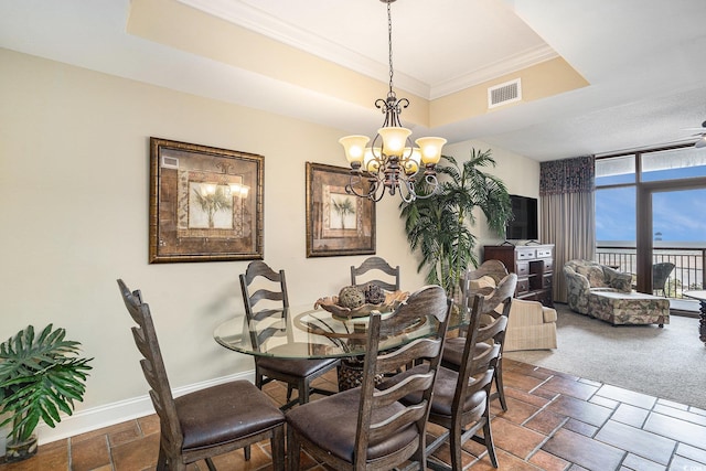 100 N Beach Blvd Unit 710, North Myrtle Beach, SC 29582 - dining area with a tray ceiling, a chandelier, and crown molding