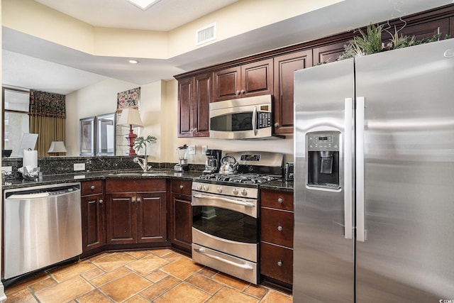 100 N Beach Blvd Unit 710, North Myrtle Beach, SC 29582 - kitchen featuring appliances with stainless steel finishes, dark brown cabinetry, dark stone countertops, and recessed lighting