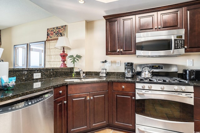100 N Beach Blvd Unit 710, North Myrtle Beach, SC 29582 - kitchen with stainless steel appliances, dark stone counters, and dark brown cabinets