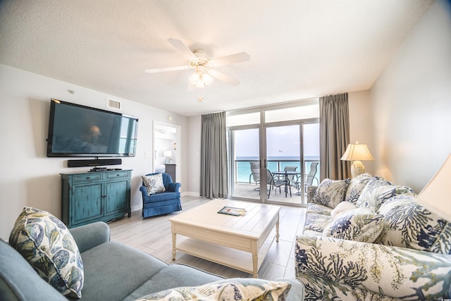 1903 S Ocean Blvd Unit 1110, North Myrtle Beach, SC 29582 - living room with ceiling fan, light wood-type flooring, and baseboards