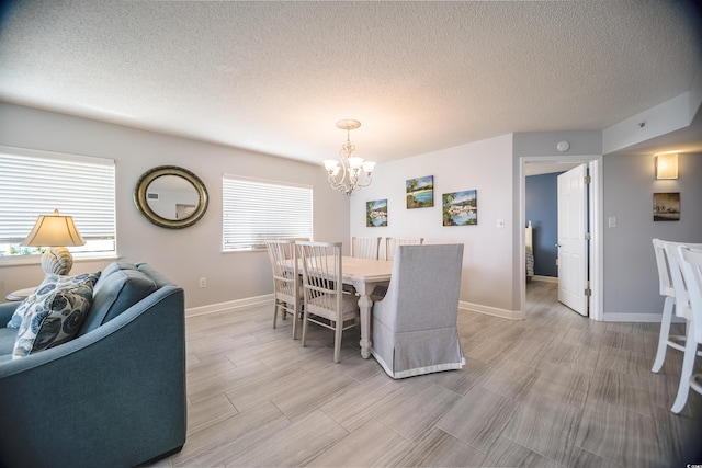 1903 S Ocean Blvd Unit 1110, North Myrtle Beach, SC 29582 - dining space with a chandelier, a textured ceiling, light wood-type flooring, and baseboards
