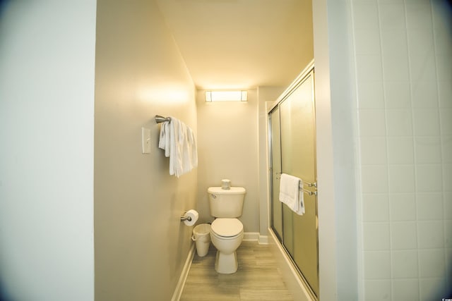 1903 S Ocean Blvd Unit 1110, North Myrtle Beach, SC 29582 - full bathroom featuring toilet, a shower stall, wood finished floors, and baseboards