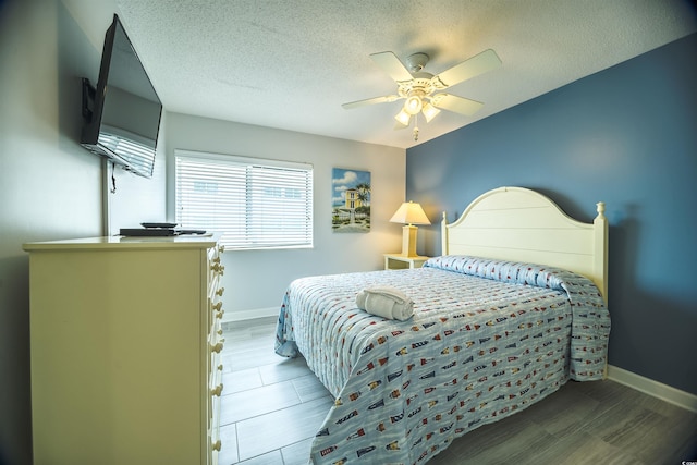 1903 S Ocean Blvd Unit 1110, North Myrtle Beach, SC 29582 - bedroom with a textured ceiling, baseboards, and a ceiling fan