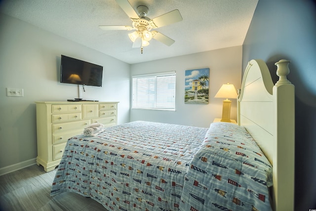 1903 S Ocean Blvd Unit 1110, North Myrtle Beach, SC 29582 - bedroom featuring baseboards, a ceiling fan, and a textured ceiling