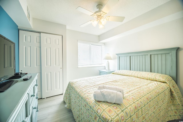 1903 S Ocean Blvd Unit 1110, North Myrtle Beach, SC 29582 - bedroom featuring a closet, light wood finished floors, a textured ceiling, and a ceiling fan