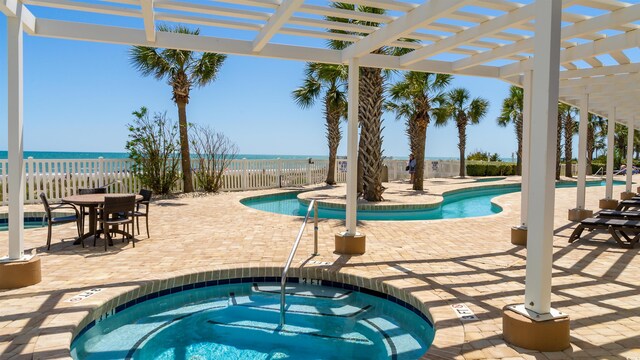 1903 S Ocean Blvd Unit 1110, North Myrtle Beach, SC 29582 - community pool with a community hot tub, a pergola, a patio, and a fenced backyard