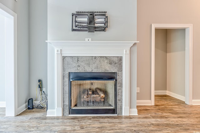 648 Sunnyside Dr Unit 102, Murrells Inlet, SC 29576 - detailed view of a tile fireplace, wood finished floors, and baseboards