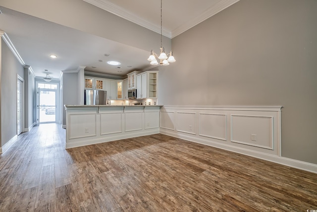648 Sunnyside Dr Unit 102, Murrells Inlet, SC 29576 - kitchen featuring appliances with stainless steel finishes, ornamental molding, dark wood-style floors, a chandelier, and open shelves