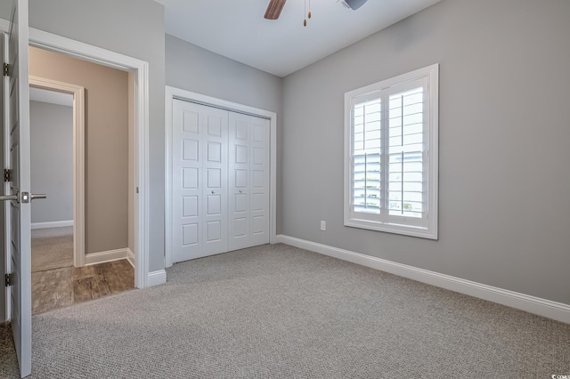 648 Sunnyside Dr Unit 102, Murrells Inlet, SC 29576 - unfurnished bedroom featuring a closet, baseboards, carpet, and ceiling fan