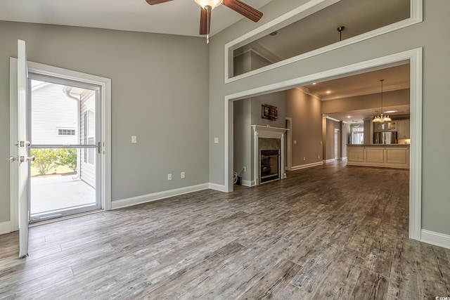 648 Sunnyside Dr Unit 102, Murrells Inlet, SC 29576 - unfurnished living room featuring ceiling fan, baseboards, a fireplace, and ornamental molding