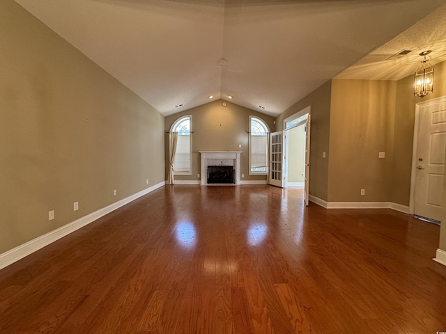 1428 Saint Thomas Cir Unit B-1, Myrtle Beach, SC 29577 - unfurnished living room featuring vaulted ceiling, a premium fireplace, dark wood-style floors, and a chandelier