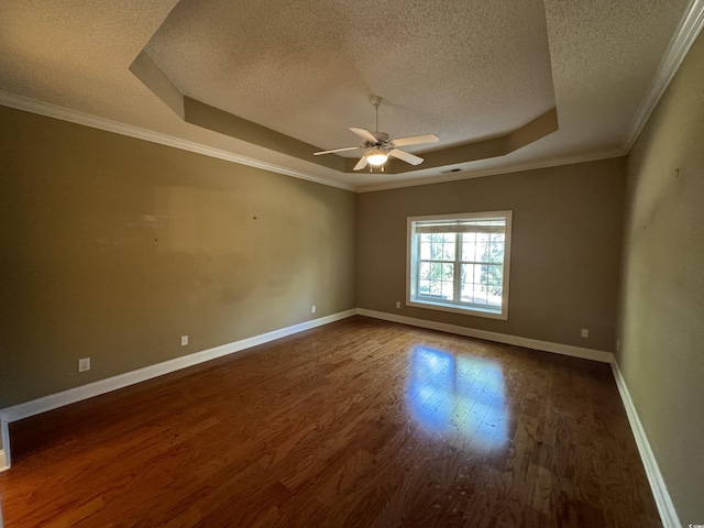 1428 Saint Thomas Cir Unit B-1, Myrtle Beach, SC 29577 - empty room with a tray ceiling, a textured ceiling, wood finished floors, a ceiling fan, and crown molding