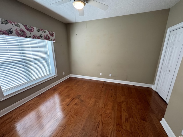 1428 Saint Thomas Cir Unit B-1, Myrtle Beach, SC 29577 - unfurnished bedroom with dark wood-style flooring, ceiling fan, and a closet