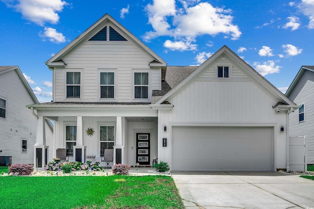 5013 Sassari St, Myrtle Beach, SC 29579 - view of front of property with board and batten siding, roof with shingles, an attached garage, and covered porch