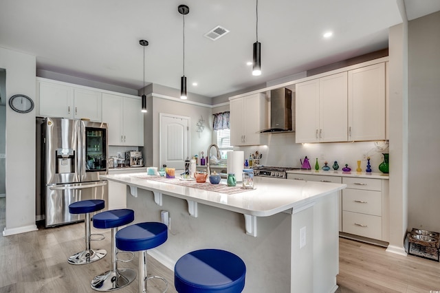 5013 Sassari St, Myrtle Beach, SC 29579 - kitchen featuring stainless steel refrigerator with ice dispenser, wall chimney exhaust hood, backsplash, light wood-style floors, and light countertops