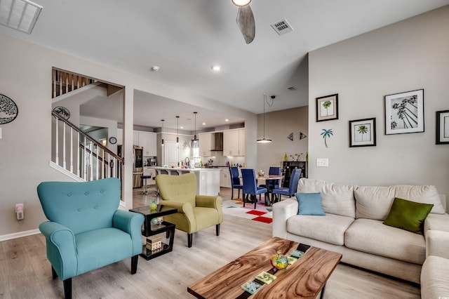 5013 Sassari St, Myrtle Beach, SC 29579 - living area featuring light wood-type flooring, stairs, a ceiling fan, recessed lighting, and baseboards