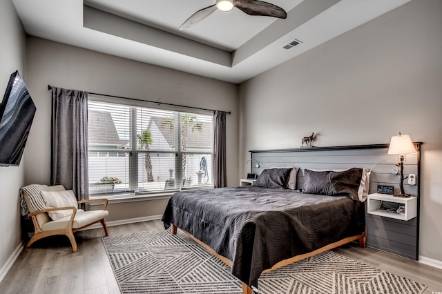 5013 Sassari St, Myrtle Beach, SC 29579 - bedroom featuring light wood-type flooring, baseboards, a raised ceiling, and a ceiling fan
