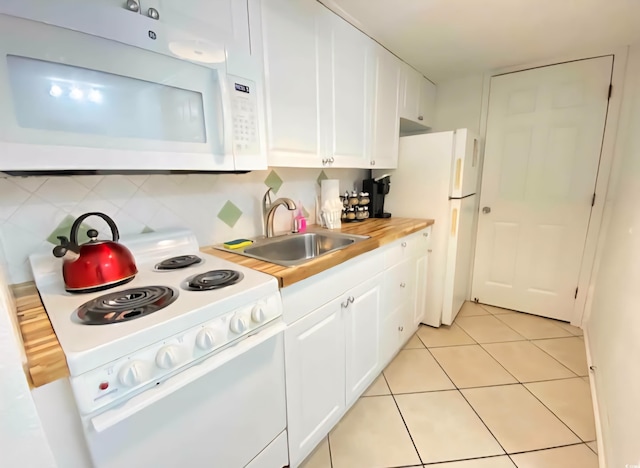 2001 S Ocean Blvd Unit 1109, Myrtle Beach, SC 29575 - kitchen featuring white appliances, white cabinets, light countertops, decorative backsplash, and light tile patterned flooring