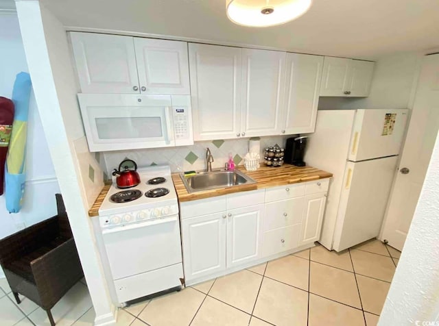 2001 S Ocean Blvd Unit 1109, Myrtle Beach, SC 29575 - kitchen with white appliances, white cabinetry, light countertops, light tile patterned floors, and decorative backsplash