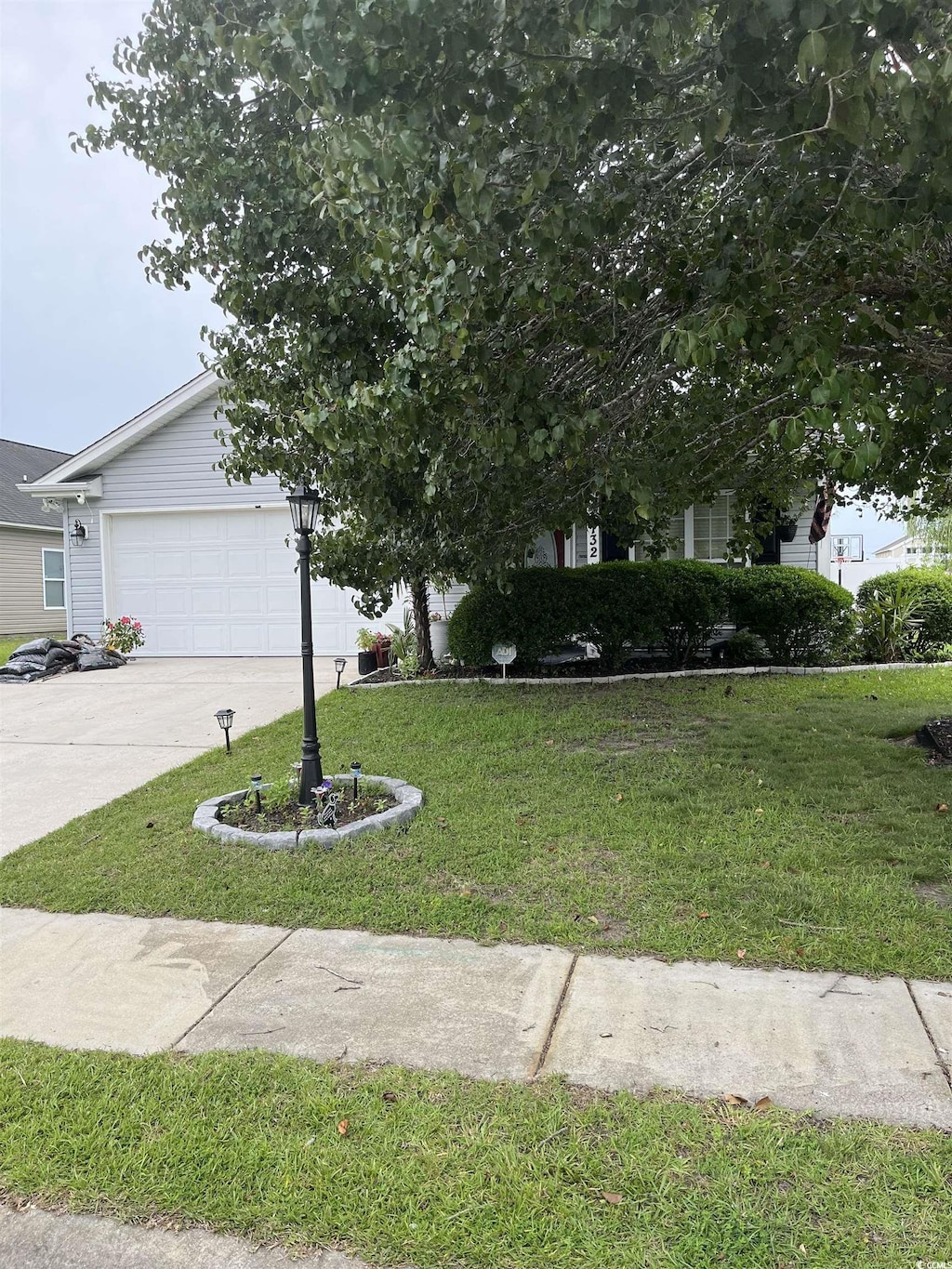 132 Carolina Pointe Way, Little River, SC 29566 - view of front facade featuring a front lawn, concrete driveway, and an attached garage