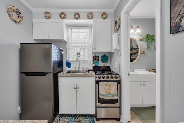 5909 N Ocean Blvd Unit 18, North Myrtle Beach, SC 29582 - kitchen with appliances with stainless steel finishes, a sink, white cabinets, ornamental molding, and light countertops