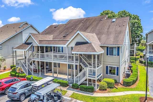 1870 Auburn Dr Unit 22A, Surfside Beach, SC 29575 - view of property with stairs, uncovered parking, and central air condition unit